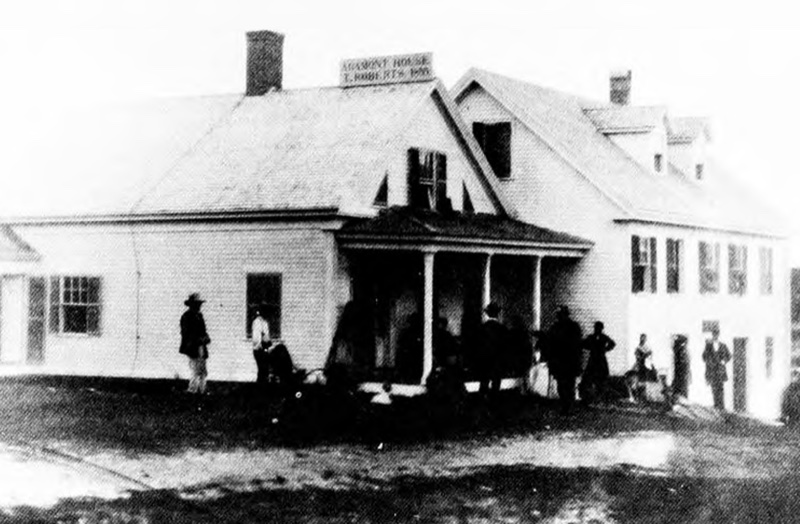 A black-and-white photograph of the small wooden Agamont House hotel with the sign 'AGAMONT HOUSE / T. ROBERTS / Estd. 1855' visible above the entrance, a handful of people standing in front.