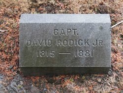 A small flat granite gravestone reading 'CAPT. DAVID RODICK JR. 1815 — 1881,' set in dry leaves on the cemetery ground.